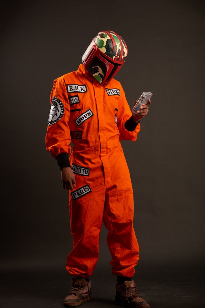 Orange jumpsuit at home with a small, stylish helmet
