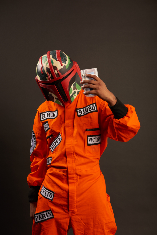 Orange jumpsuit at home with a small, stylish helmet